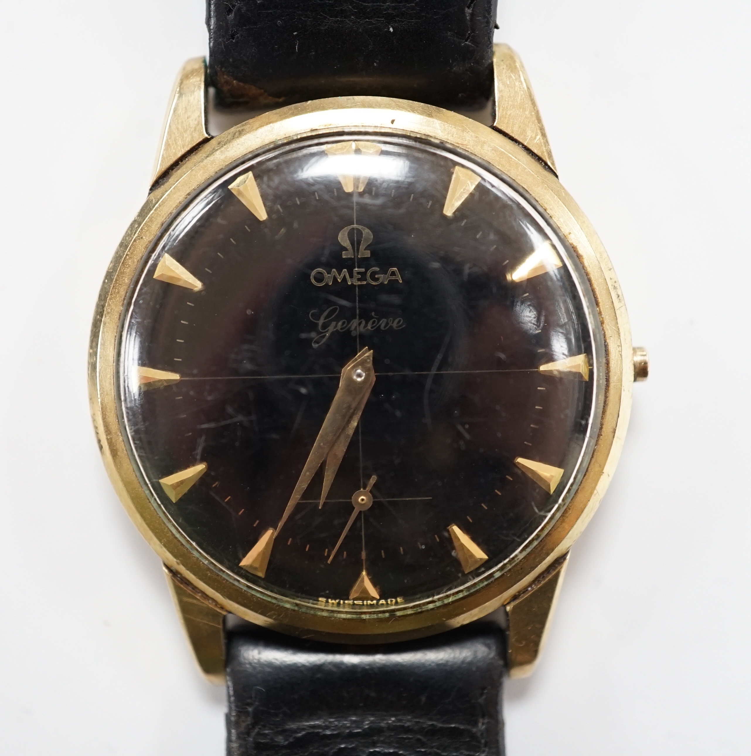 A gentleman's 9ct gold Omega manual wind black dial wrist watch (lacking winding crown), on associated leather strap, case diameter 35mm.